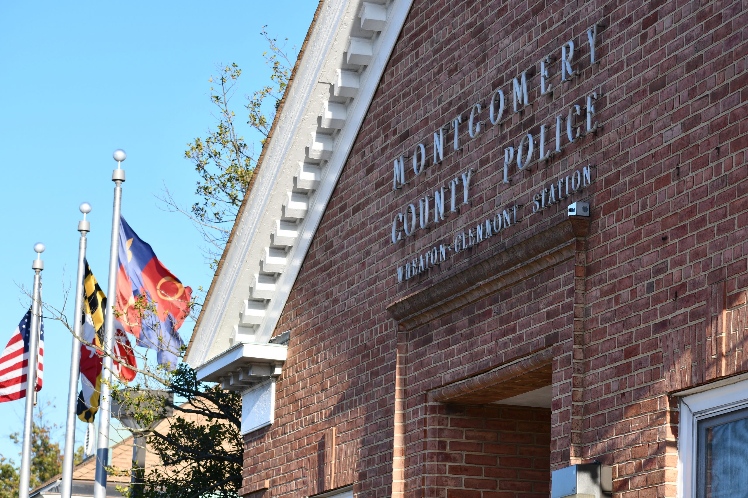 Exterior shot of 4th district Montgomery County Police Department building and Maryland and U.S. flag
