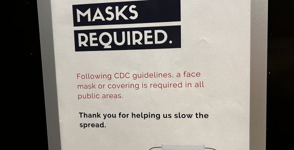 A photo of a sheet of paper that says masks are required to be worn indoors.