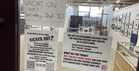 Artists protesting re-jurying process with signs outside studio