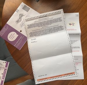a photo of a D.C. voter's ballot spread out on a wooden table. The ballot is flipped over to the back to show Initiative 82 with "vote yes to approve" and "vote no to reject" options below