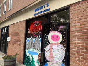 The outside door and window of Minsky's is painted with a wintery scene.