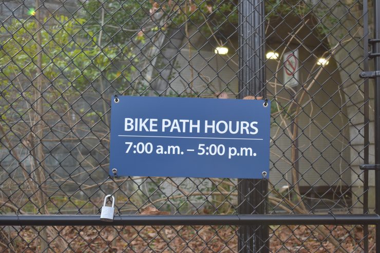 A sign on the Zoo Loop Trail's gate reads "Bike Path hours: 7 a.m. to 5 p.m."