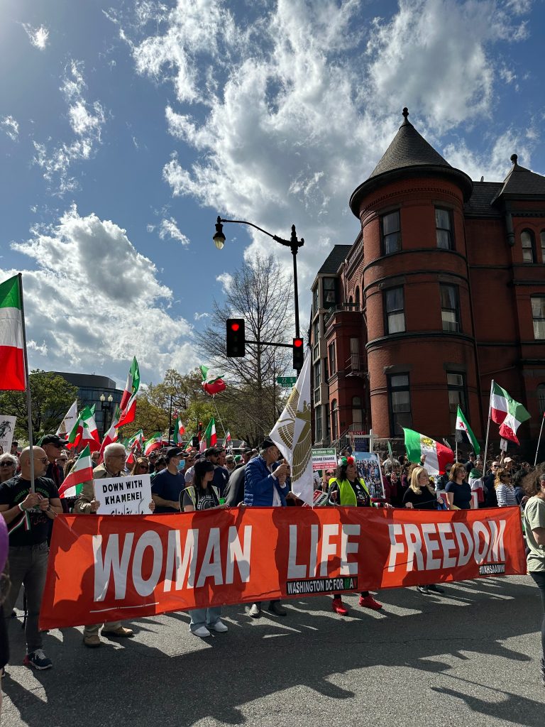 Protestors in Washington DC hold a banner that says "WOMAN LIFE FREEDOM".