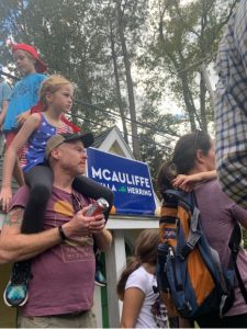 Father and daughter attending a political rally