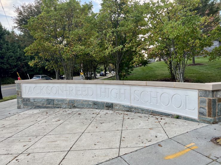 Photo of a stone sign reading "Jackson-Reed High School"