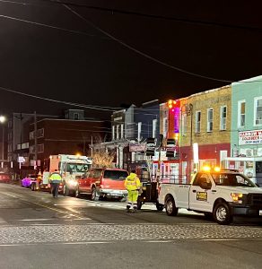 a street at night lined with flashing emergency vehicles