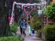 Family walking near decorated porches during the Petal Porch festivities
