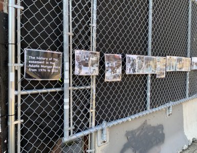A fence with posters.