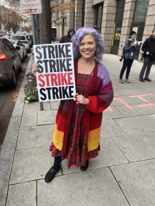 Post staff writer, Gillian Brockell, holds a "STRIKE" poster.