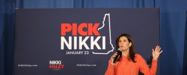 Nikki Haley speaks on stage to a crowd at a rally.