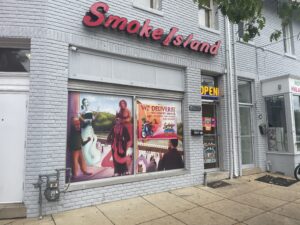 A grey storefront with the words "Smoke Island."