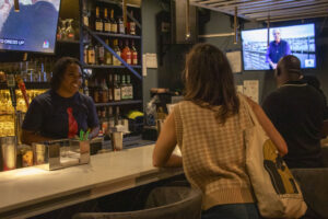 A customer orders a drink at the bar.