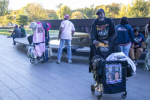 A merchandise seller stands outside of the National Museum of African American History.