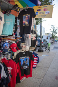 Kamala Harris and Donald Trump T-shirts on display at a street vendor's truck.