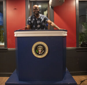 Co-owner Drew Benbow stands behind the DJ booth on the bar's second floor. (Maria Lawson / The Wash)