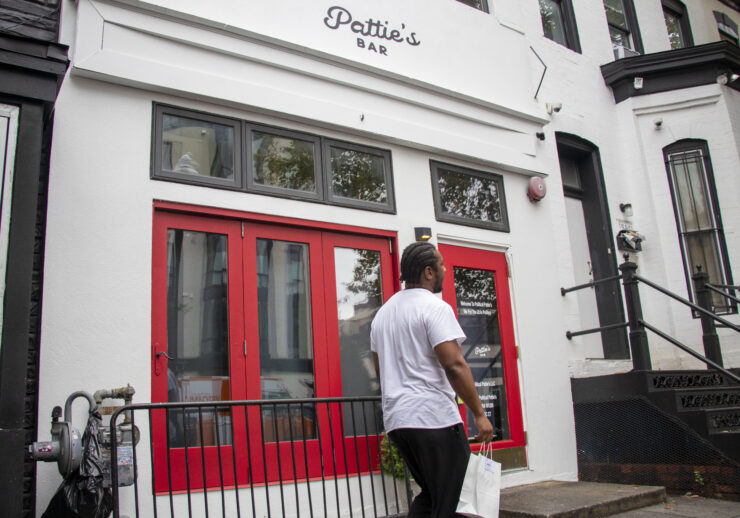 A man walks outside of Political Pattie's.