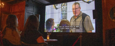 Two women watch Love is Blind at The Crown & Crow.