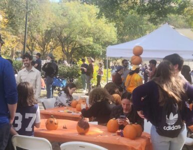 Festivalgoers gathered around tables set up in the park, painting pumpkins and engaging in conversations. Dupont Circle’s Fall Festival, Saturday, Oct. 26. Photo by Hajar Aboueddahab