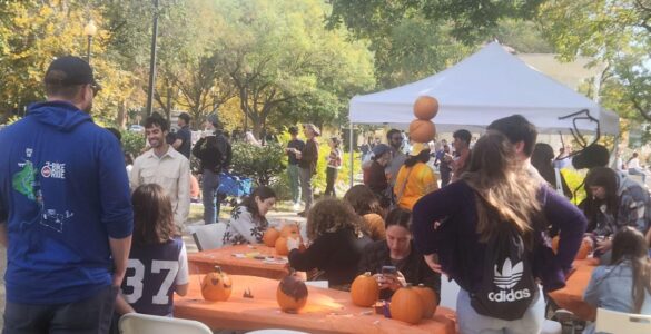 Festivalgoers gathered around tables set up in the park, painting pumpkins and engaging in conversations. Dupont Circle’s Fall Festival, Saturday, Oct. 26. Photo by Hajar Aboueddahab