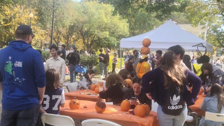 Festivalgoers gathered around tables set up in the park, painting pumpkins and engaging in conversations. Dupont Circle’s Fall Festival, Saturday, Oct. 26. Photo by Hajar Aboueddahab