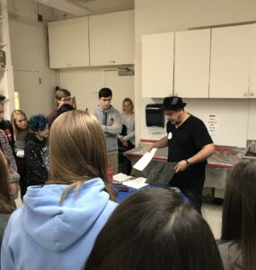 Students at Yorktown High School, a public high school in Arlington, Va., watch an art demonstration during class.