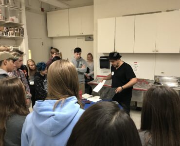 Students at Yorktown High School, a public high school in Arlington, Va., watch an art demonstration during class.