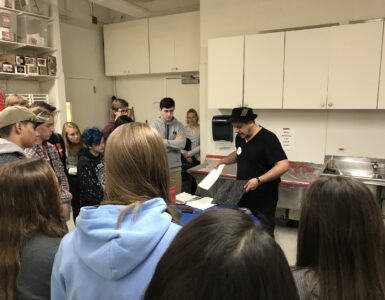 Students at Yorktown High School, a public high school in Arlington, Va., watch an art demonstration during class.