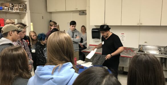 Students at Yorktown High School, a public high school in Arlington, Va., watch an art demonstration during class.