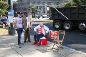 Shea for Shaw supporters stand outside of the Shaw Library on Election Day.