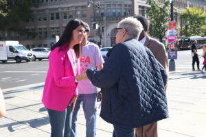 D.C. Councilmember talks to Shaw resident Jacqueline Gore outside of the Shaw Library on election day.