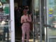 A woman walks toward the door to exit the Shaw Library.