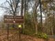 A sign for the Rock Creek Nature Center stands amid autumn leaves in Rock Creek Park. Photo by Jordan Thorton.