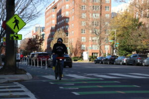 A man rides a bike near Logan Circle.