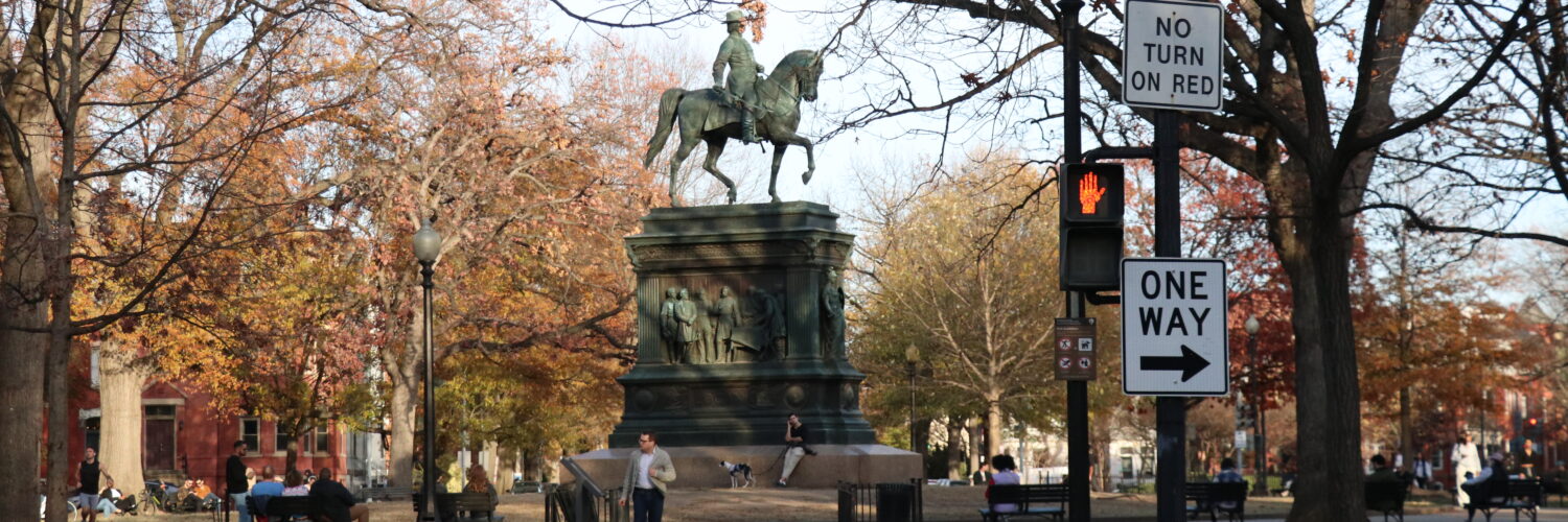 The Logan Circle statue with people surrounding.