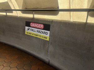 A sign reads, "Danger: Fall Hazard. Do not attempt to climb."