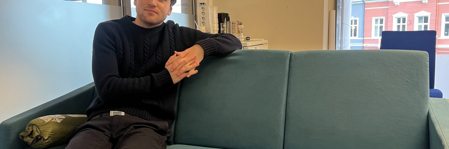 Mikkel Røed Nesse poses on a couch