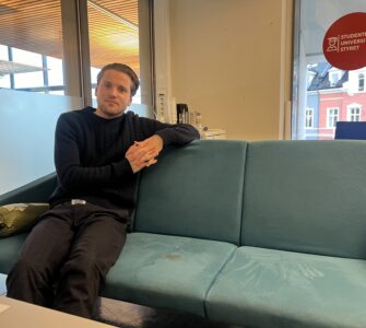 Mikkel Røed Nesse poses on a couch