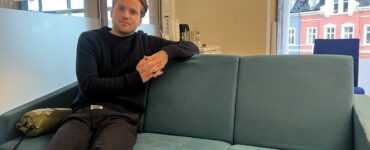 Mikkel Røed Nesse poses on a couch