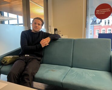 Mikkel Røed Nesse poses on a couch