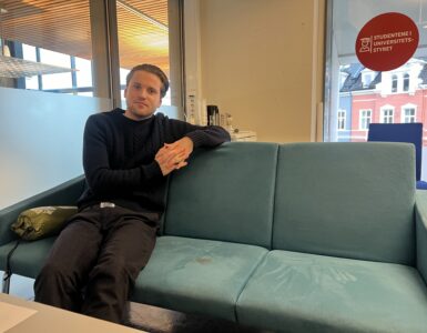 Mikkel Røed Nesse poses on a couch