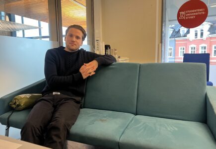 Mikkel Røed Nesse poses on a couch