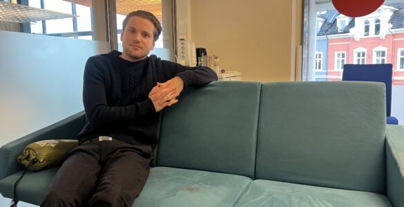 Mikkel Røed Nesse poses on a couch