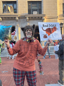 Government cutbacks protester with a furry hat.
