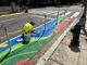 Artist Samantha Hamilton painting a street mural on Capitol Hill as part of Color Your Curb. (Ellen Tannor)