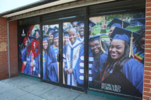 Graduating students pose with President Wayne A. I. Federick in a photo mural on campus. (Terrance Williams)