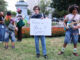 Nick Ransom, winner of the performative male contest, stands victorious while holding the sign for the competition. (Kelly Doyle)