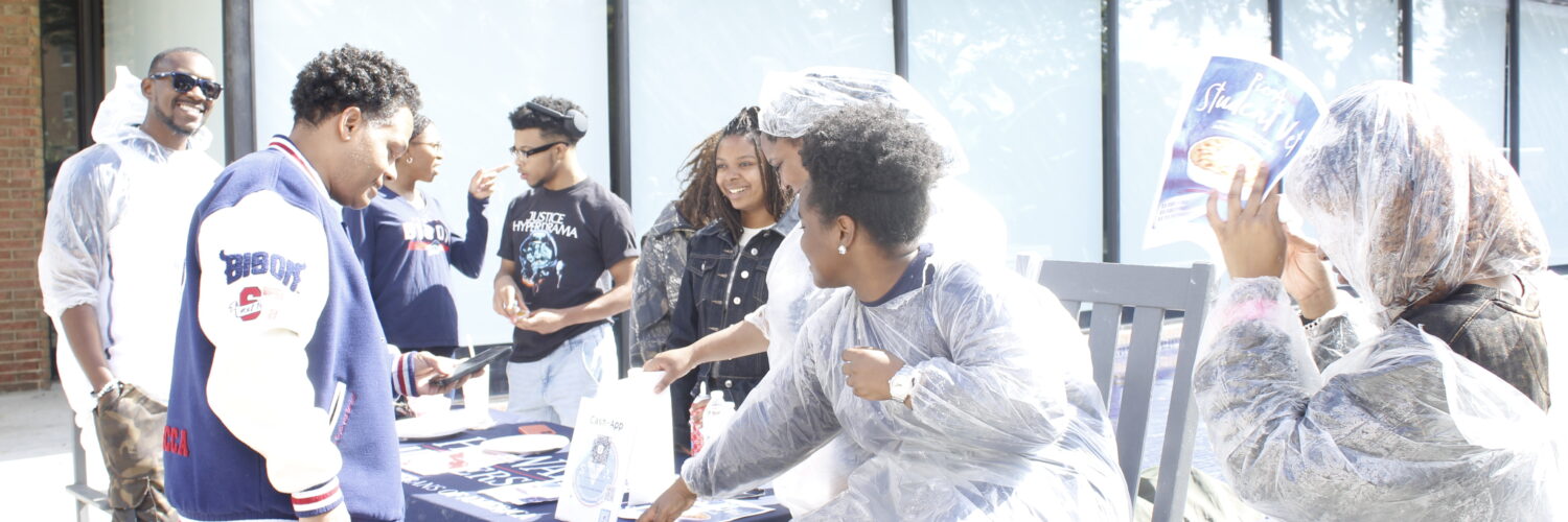 Members of the SVA host a fundraiser in front of the Blackburn Center while trying to convince Dr. Paris Adon, left, to join.