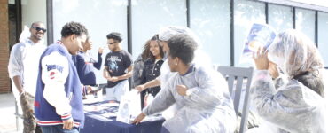 Members of the SVA host a fundraiser in front of the Blackburn Center while trying to convince Dr. Paris Adon, left, to join.