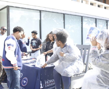 Members of the SVA host a fundraiser in front of the Blackburn Center while trying to convince Dr. Paris Adon, left, to join.