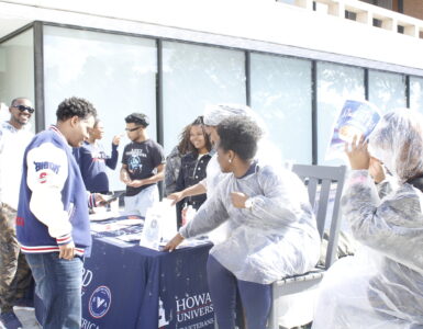 Members of the SVA host a fundraiser in front of the Blackburn Center while trying to convince Dr. Paris Adon, left, to join.